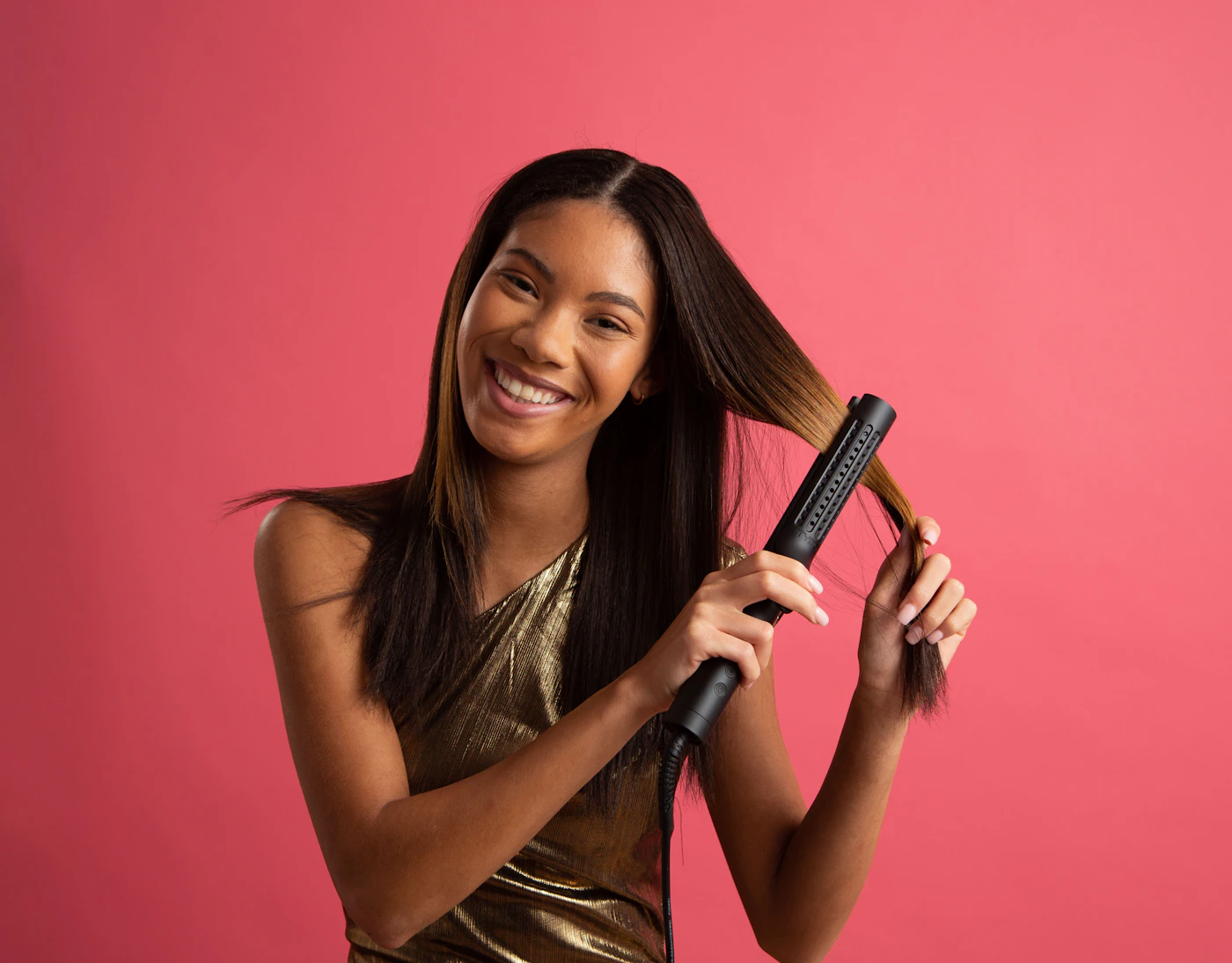 Woman styling her hair with a beauty hair tool