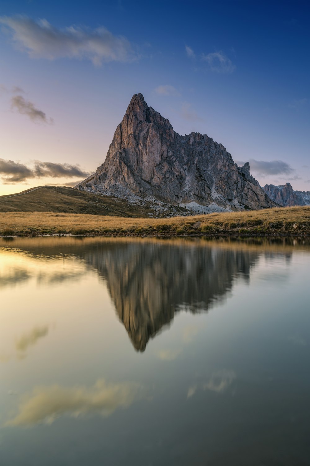 a mountain is reflected in the still water of a lake