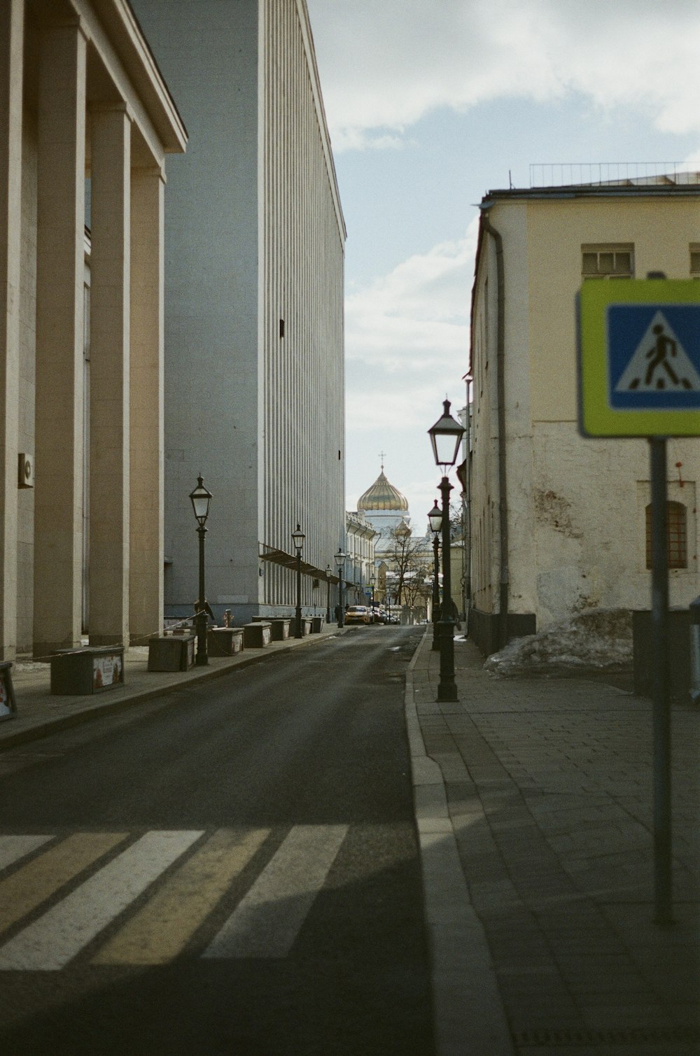 a city street with buildings and a street sign