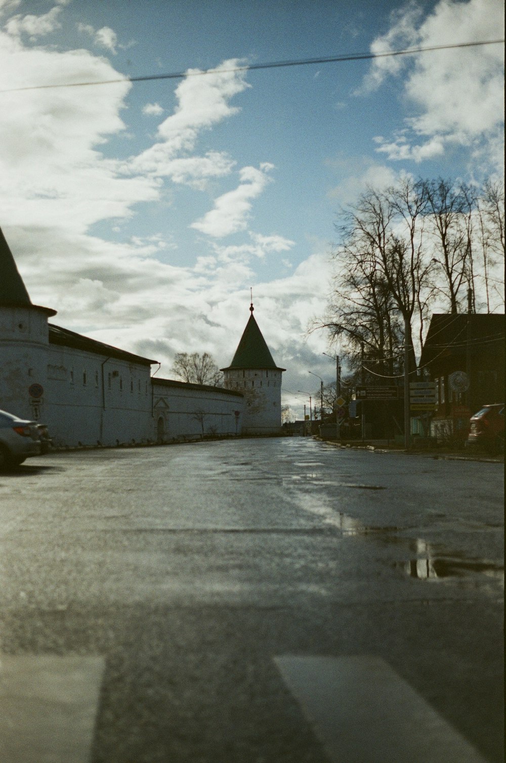 an empty street with a church in the background