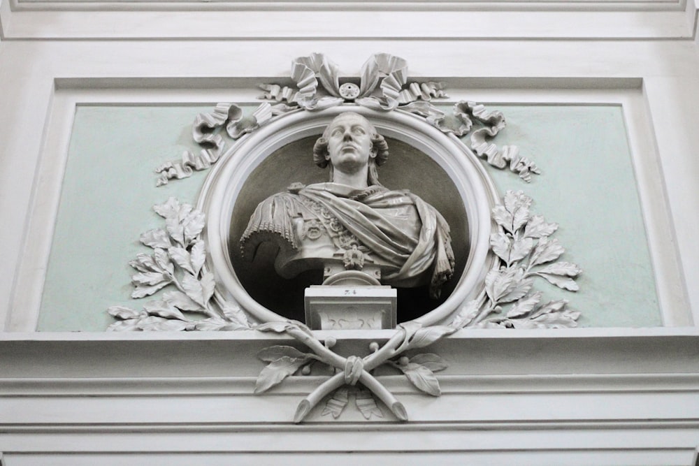 a statue of a man with a crown on top of a building