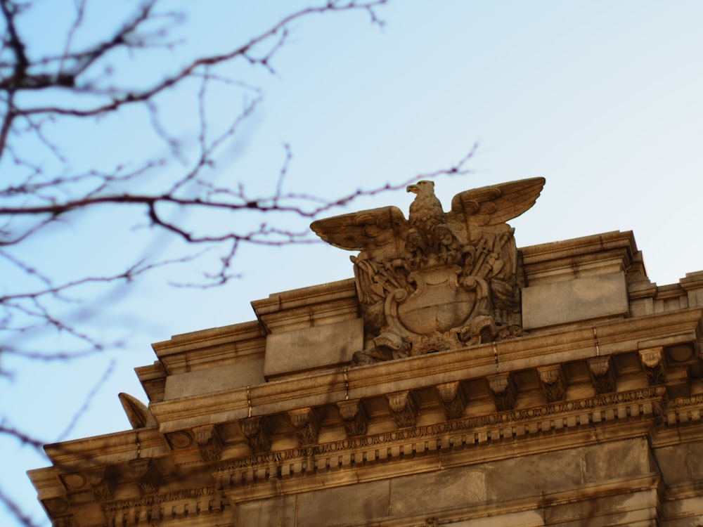 a statue of a bird on top of a building