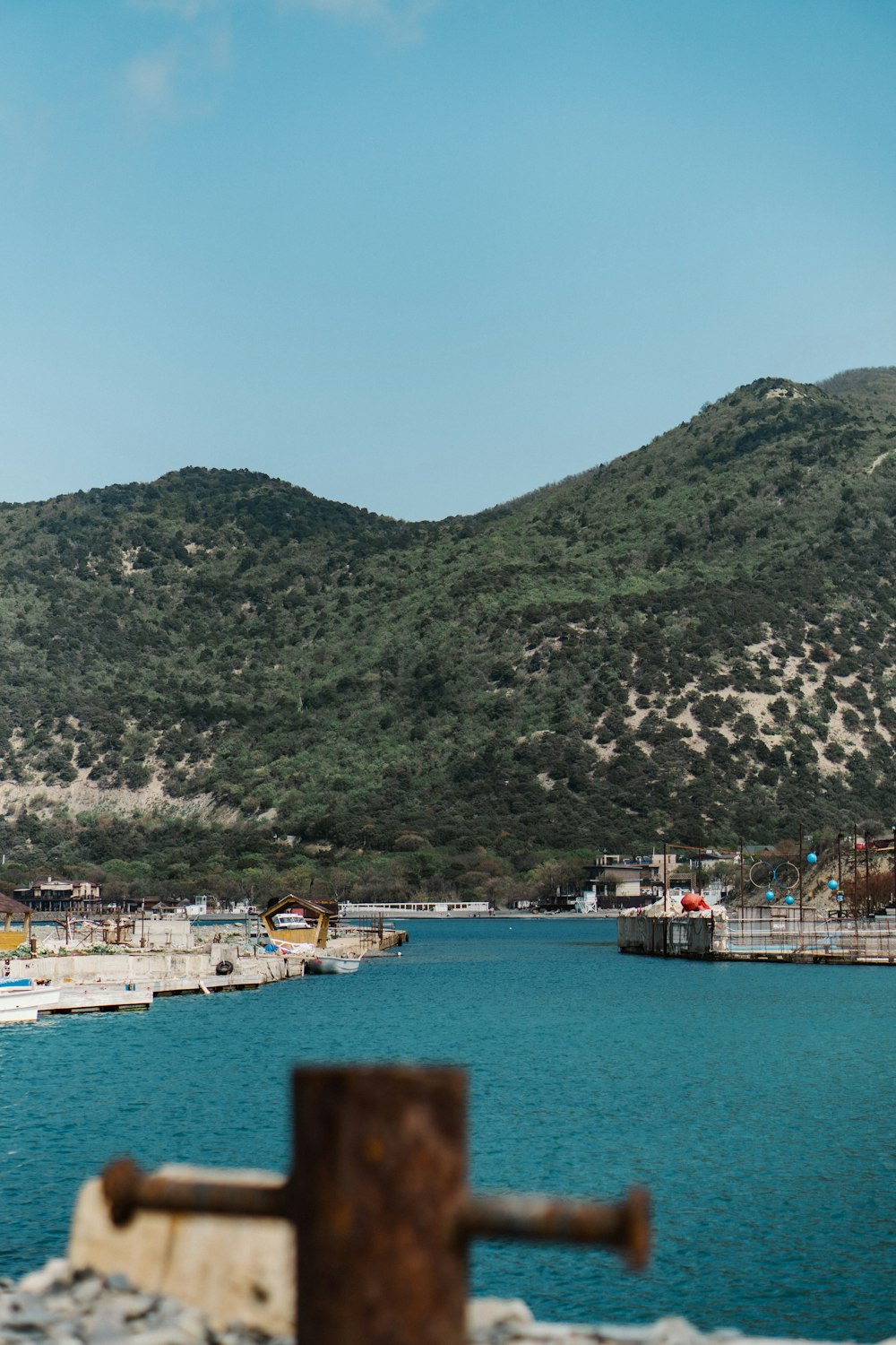 a body of water with a mountain in the background