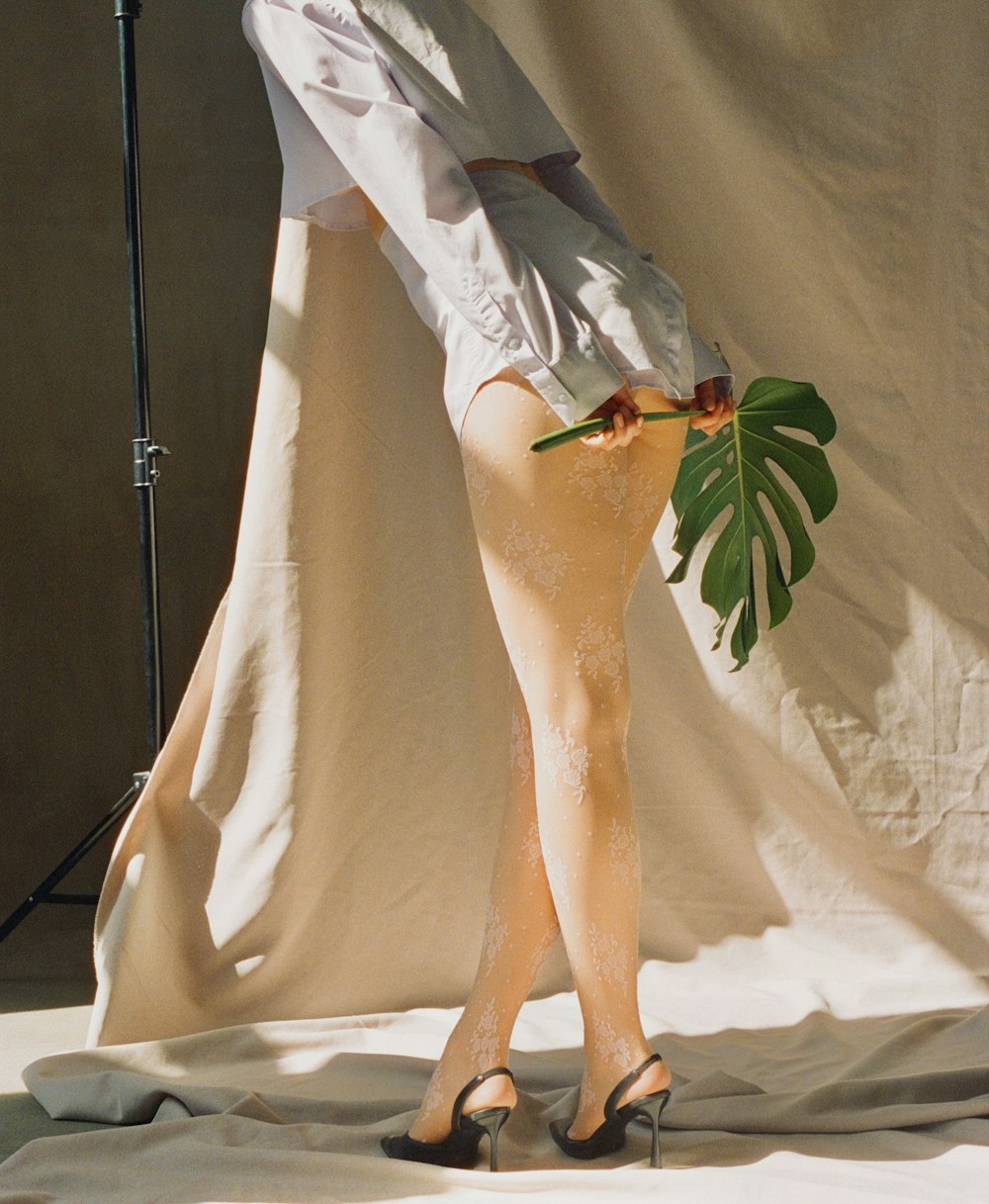 a woman in high heels and a white shirt