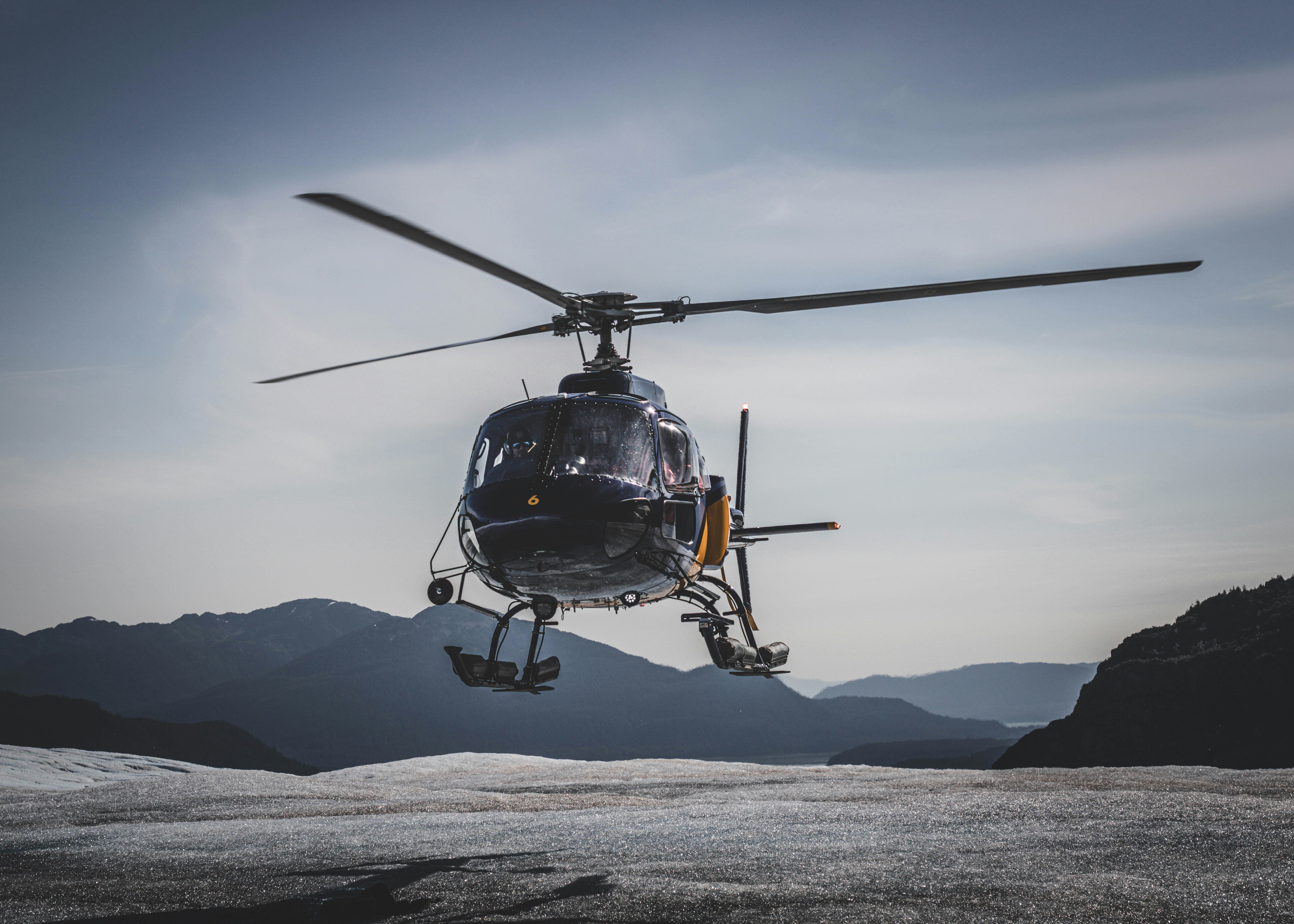 a helicopter is flying over a mountain range, Helicopter ride to Mendenhall Glacier