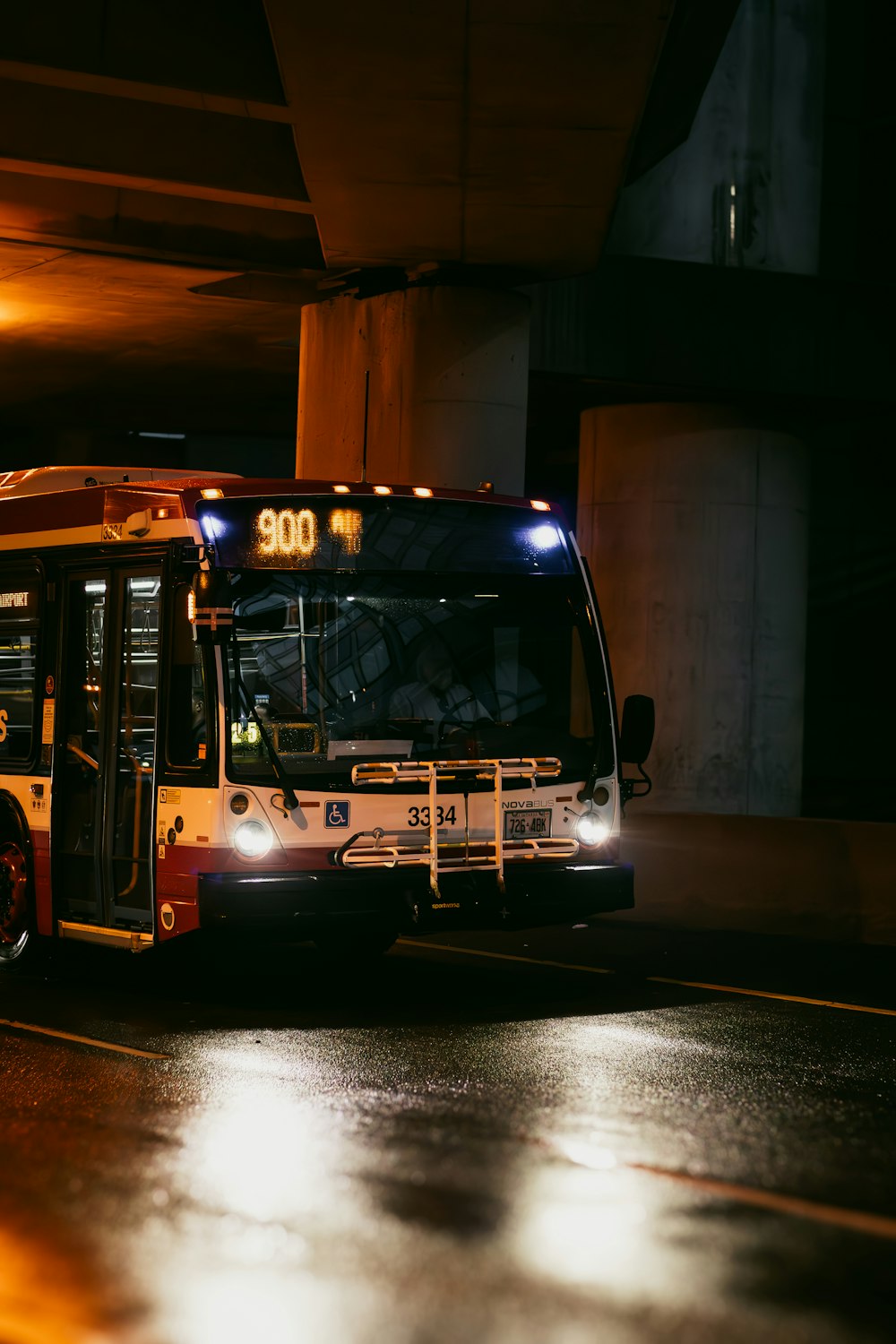 a city bus driving down a street at night