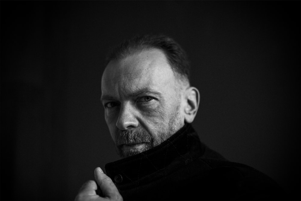 a black and white photo of a man with a goatee