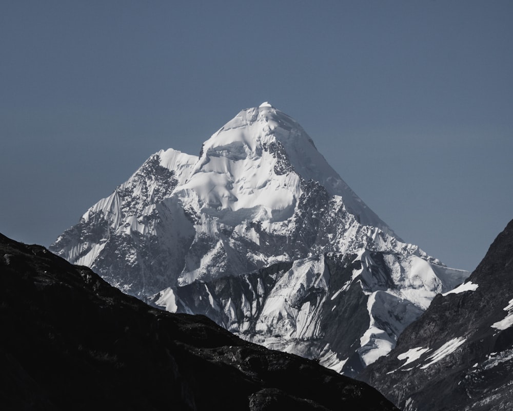 a large snow covered mountain with a sky background