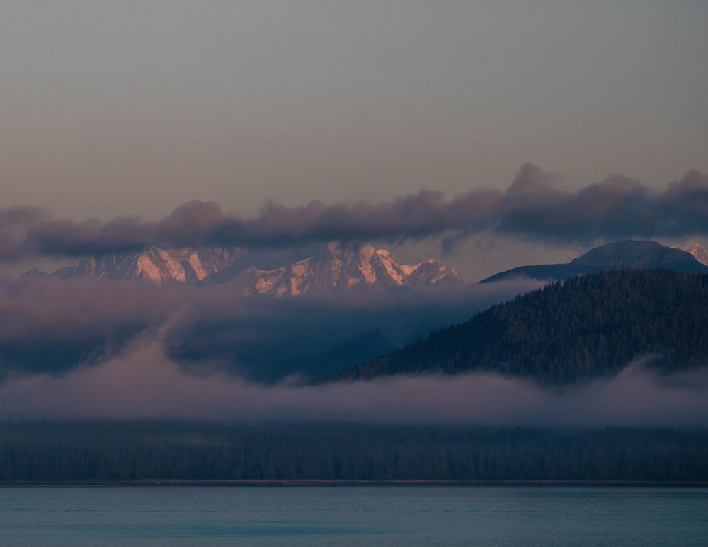 a view of a mountain range covered in clouds