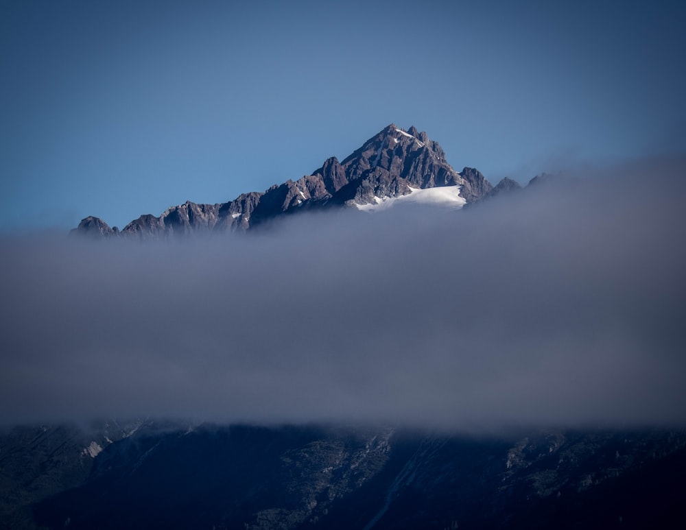 a view of a mountain covered in clouds