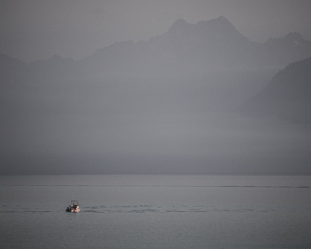 a small boat in the middle of a large body of water