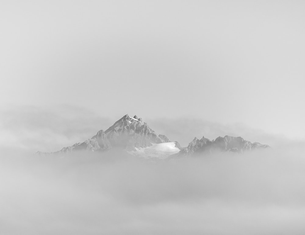 a black and white photo of a snowy mountain