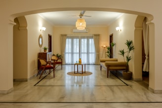 a living room filled with furniture and a ceiling fan