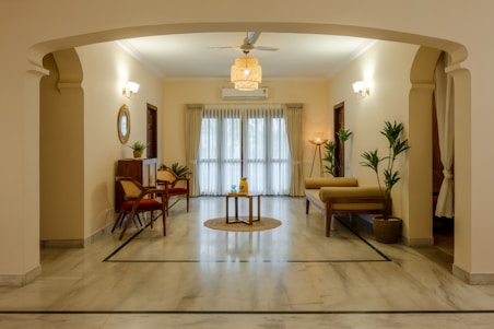 a living room filled with furniture and a ceiling fan