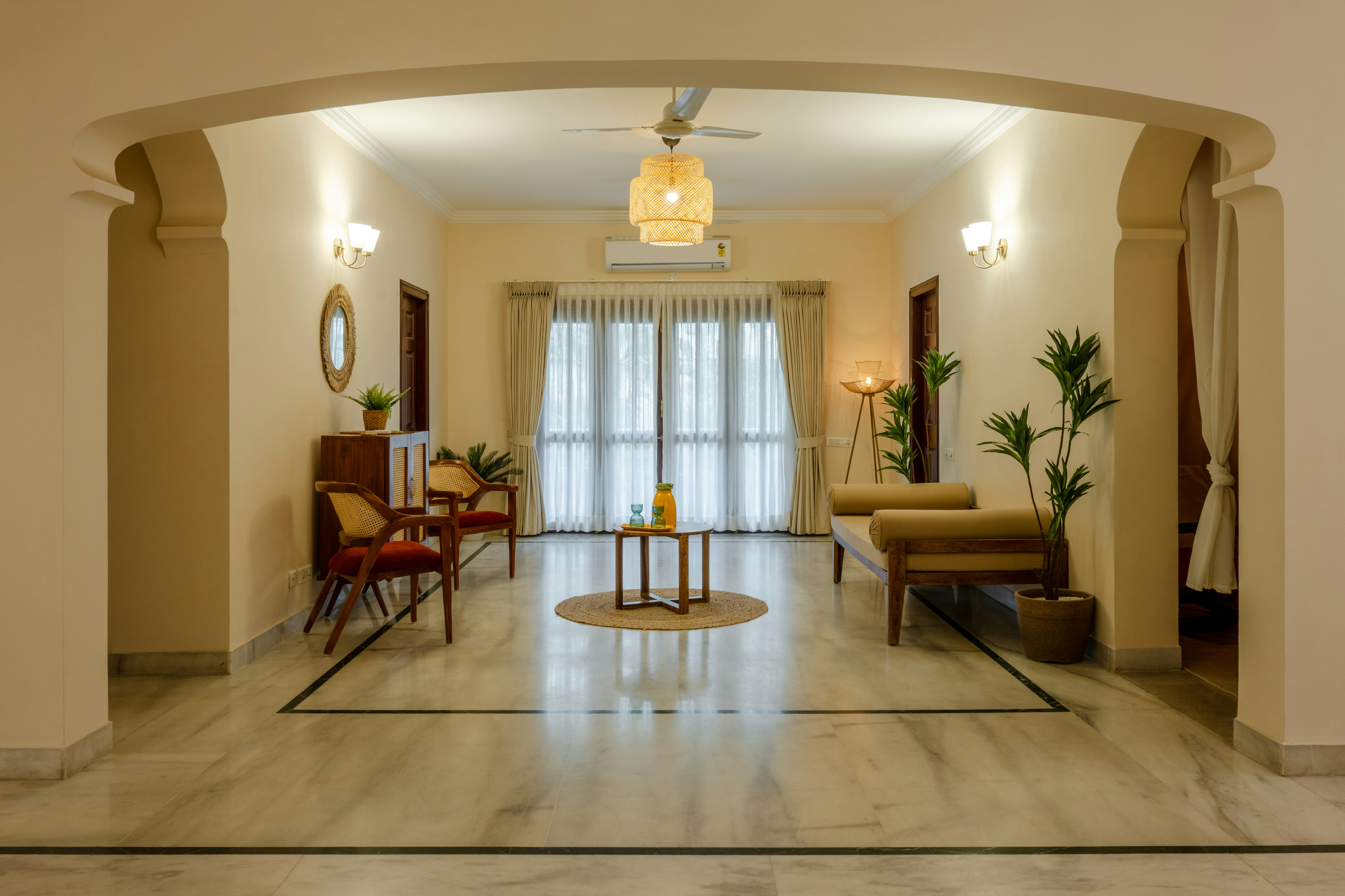 a living room filled with furniture and a ceiling fan
