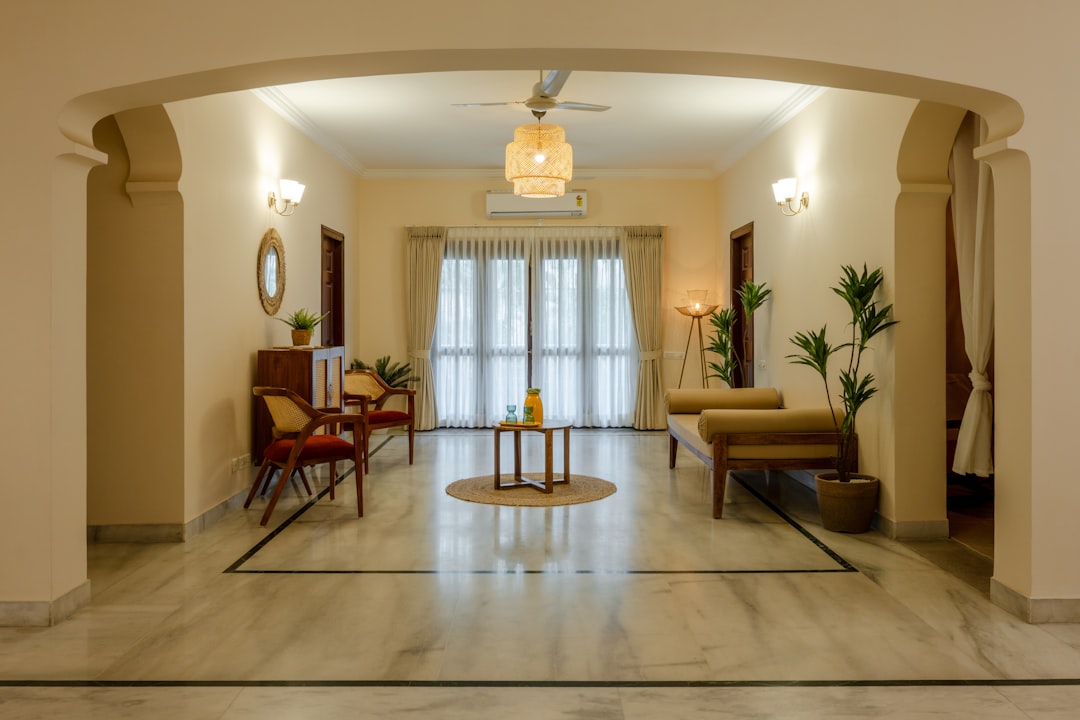 a living room filled with furniture and a ceiling fan,