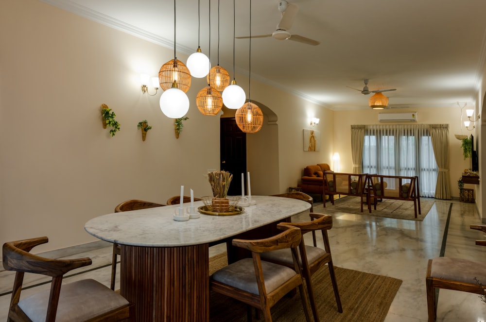 a dining room with a marble table and chairs