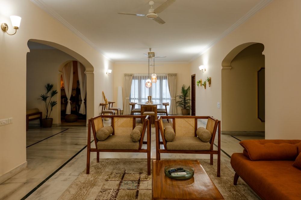 a living room filled with furniture and a ceiling fan