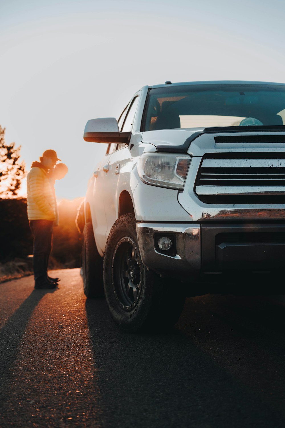 a man standing next to a white truck