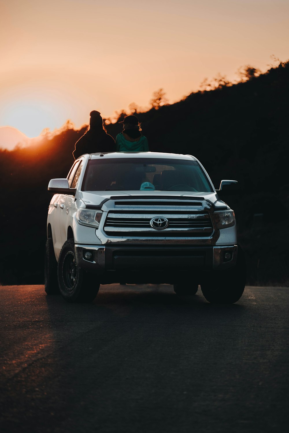 a white truck parked on the side of a road