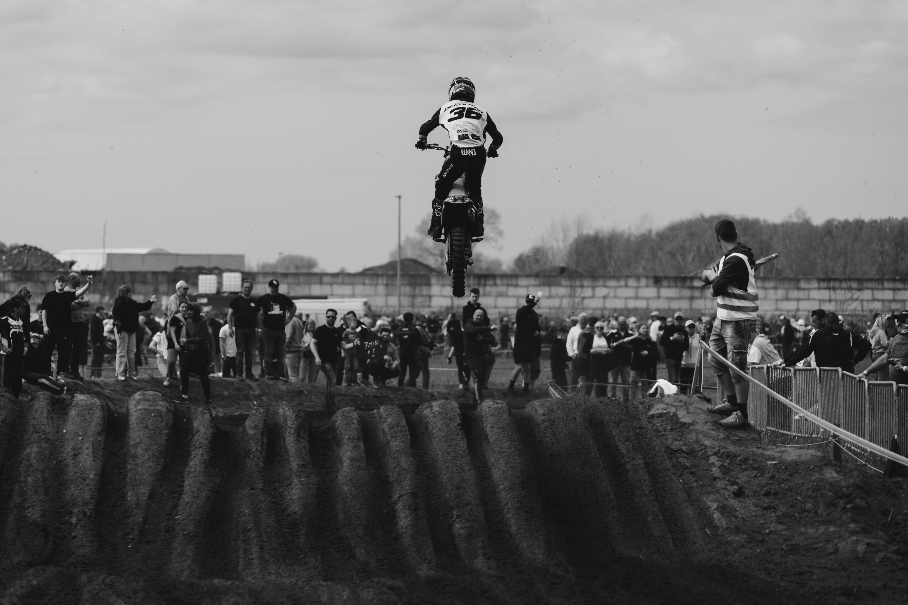 a man riding a dirt bike on top of a dirt field