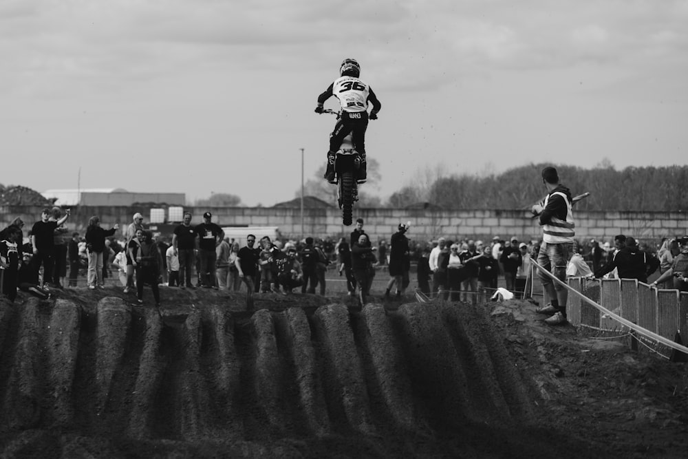 a man riding a dirt bike on top of a dirt field