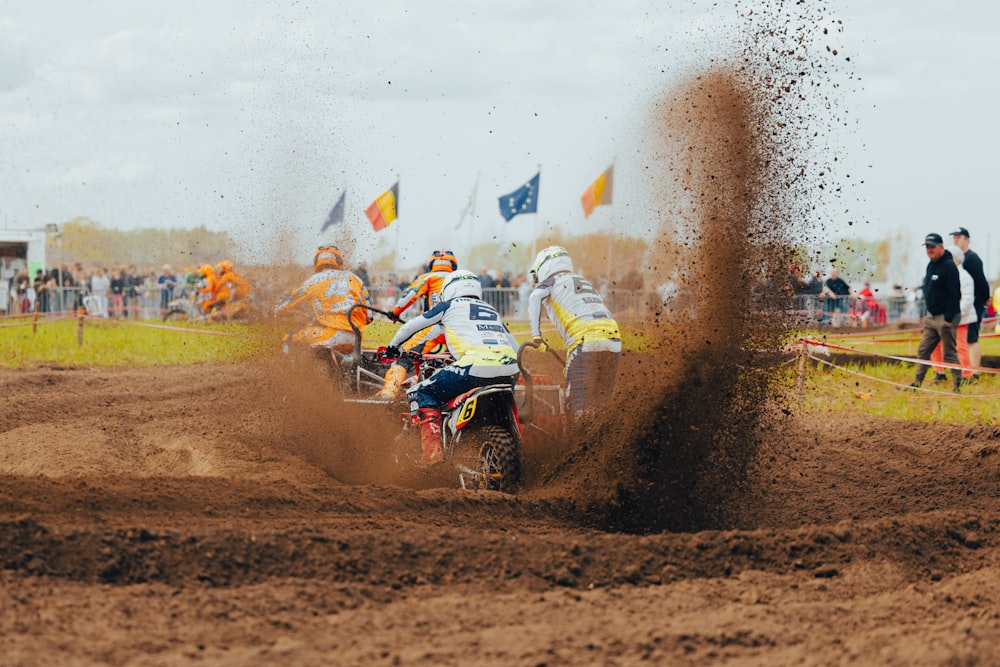 a man riding a dirt bike on top of a dirt field