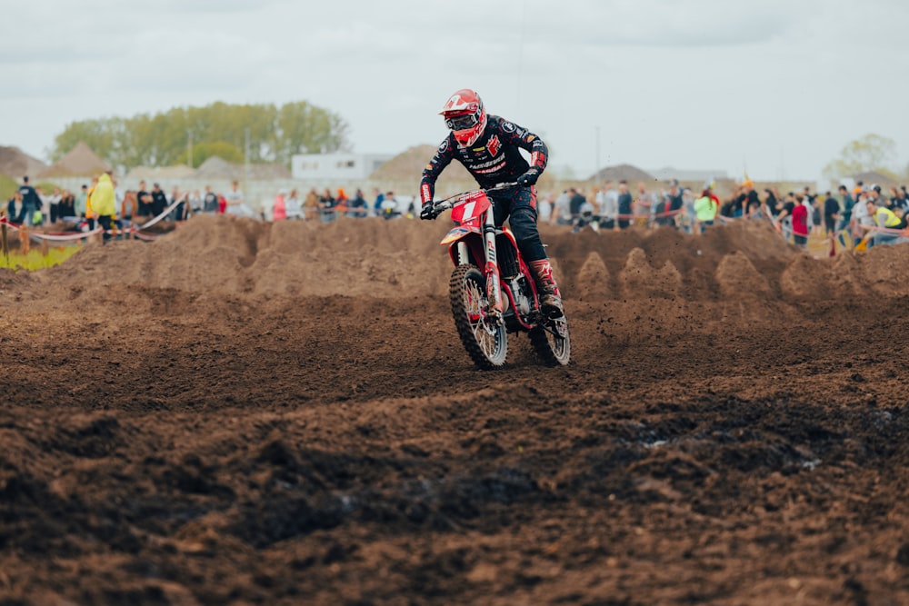 a man riding a dirt bike on top of a dirt field