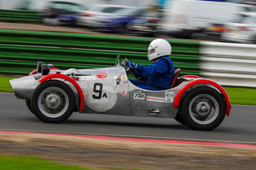 a man driving a race car on a track