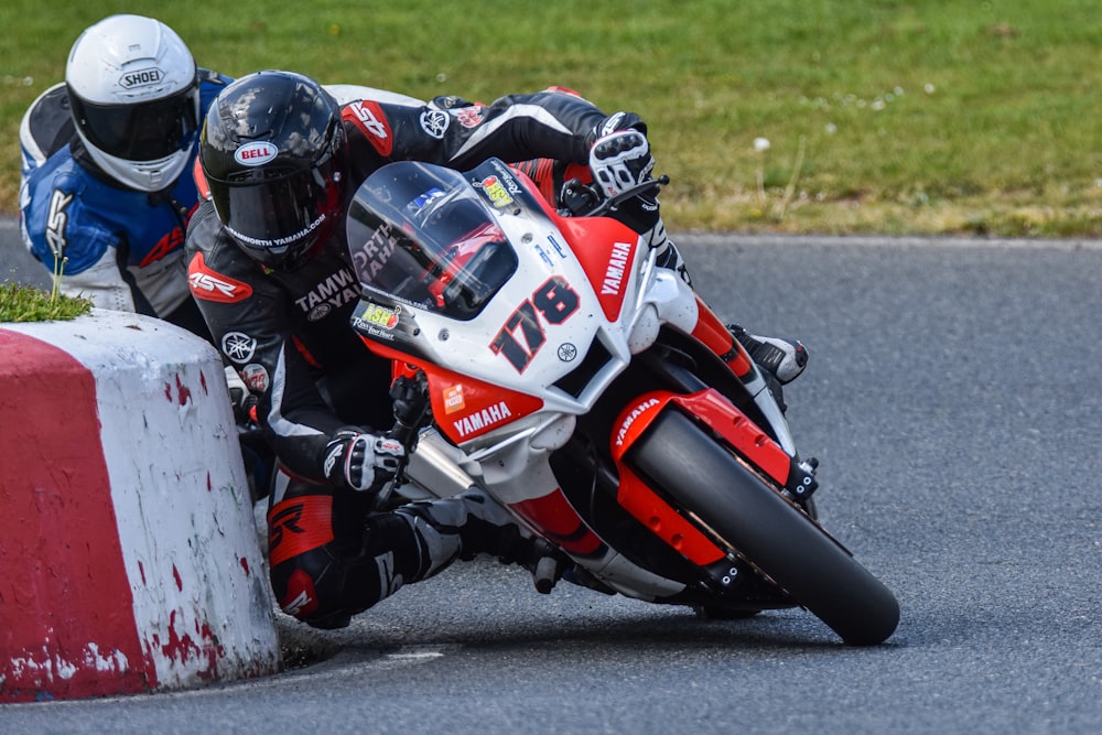 a person riding a motorcycle around a corner