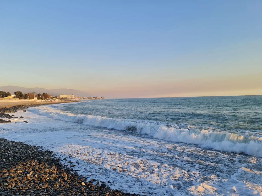 a view of a beach with waves coming in to shore