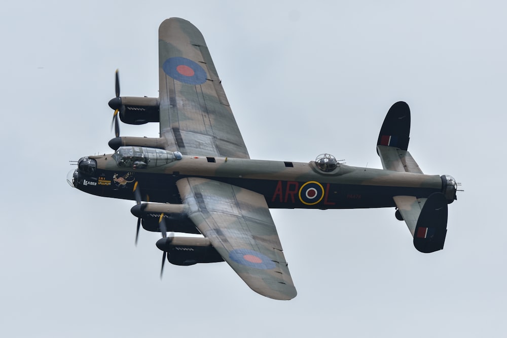 a plane flying in the air with a sky background