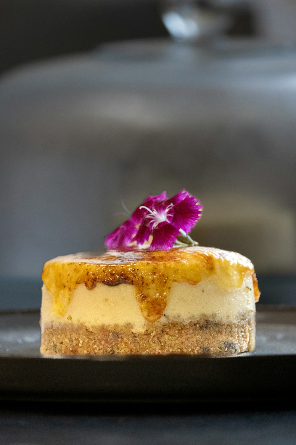 a piece of cheesecake with a flower on top