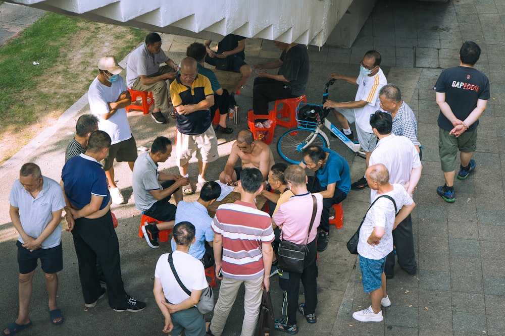 a group of people standing around each other