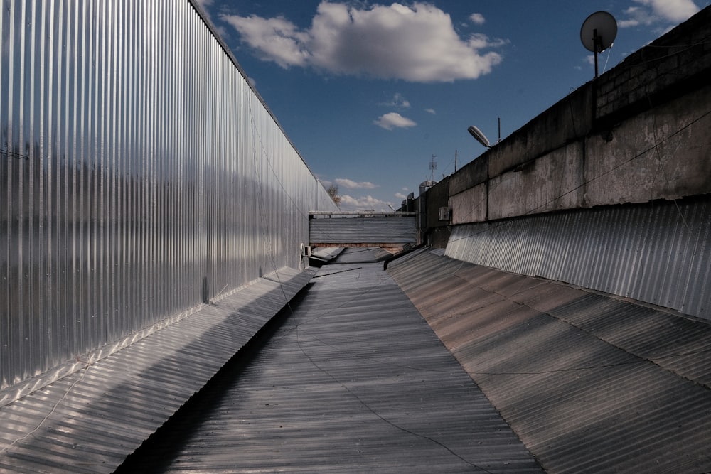 a long metal walkway with a sky background