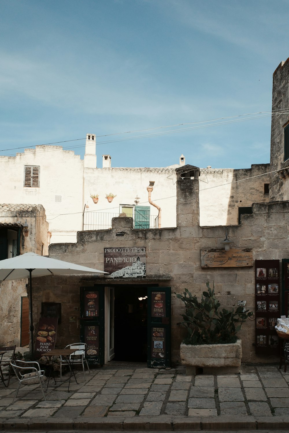 a building with tables and chairs outside of it