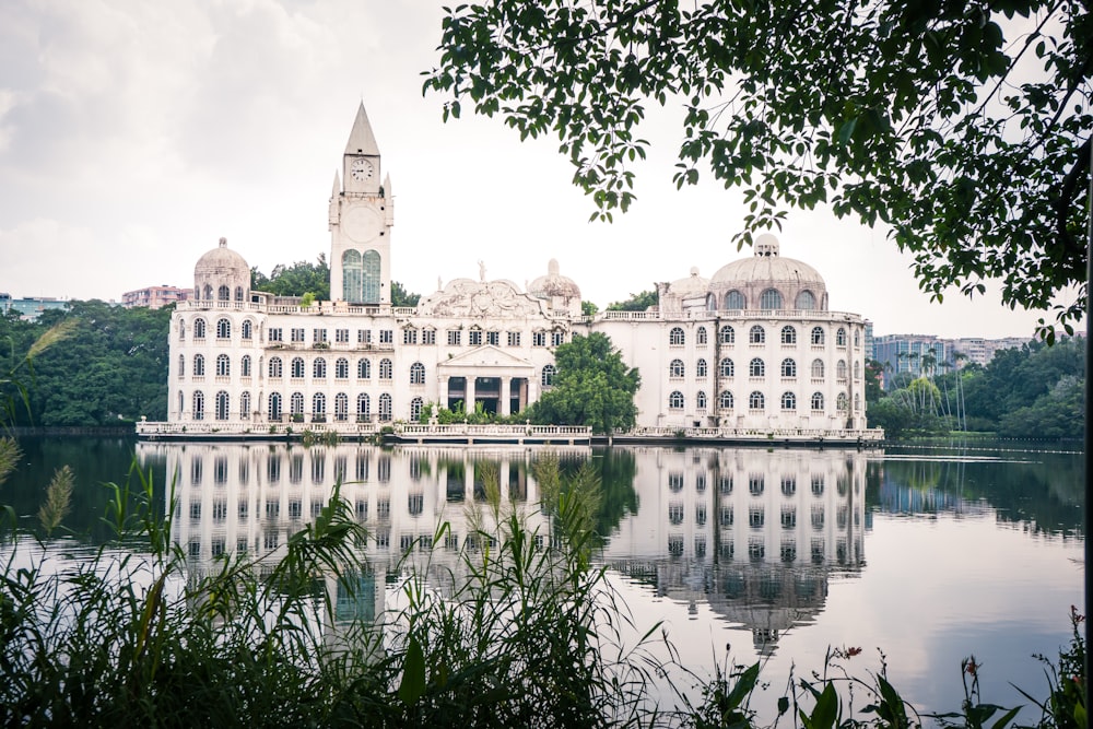 a large white building sitting on top of a lake