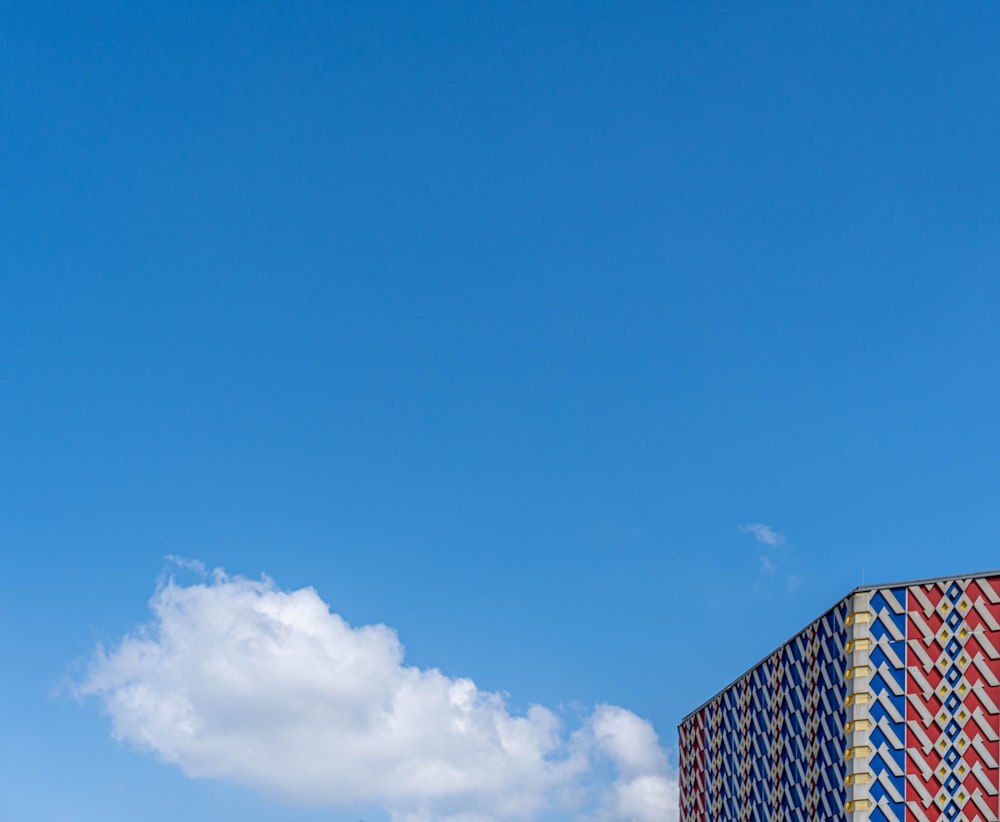 a tall building with a blue sky in the background