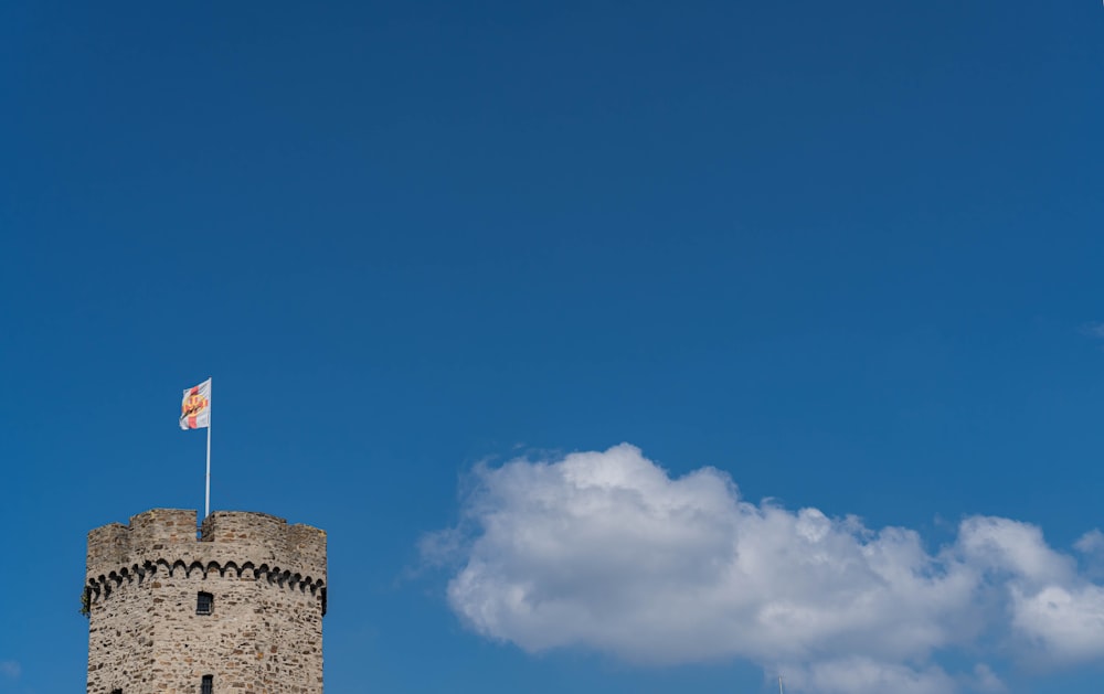 a tall tower with a flag on top of it