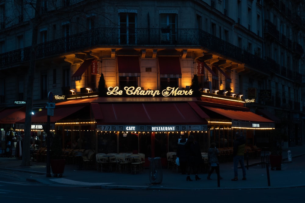 a building with a red awning at night