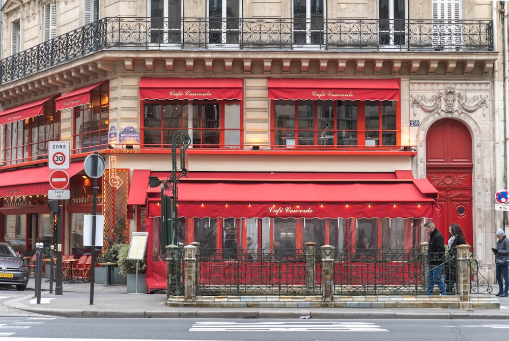 a red building with people standing outside of it