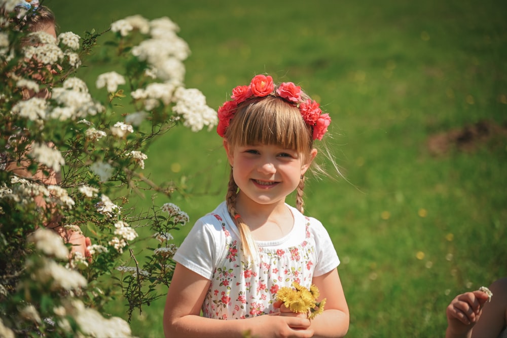 a little girl standing in a field of flowers