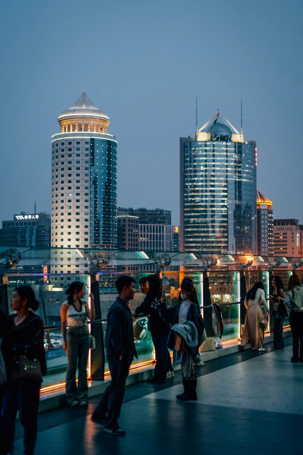 a group of people standing on top of a bridge