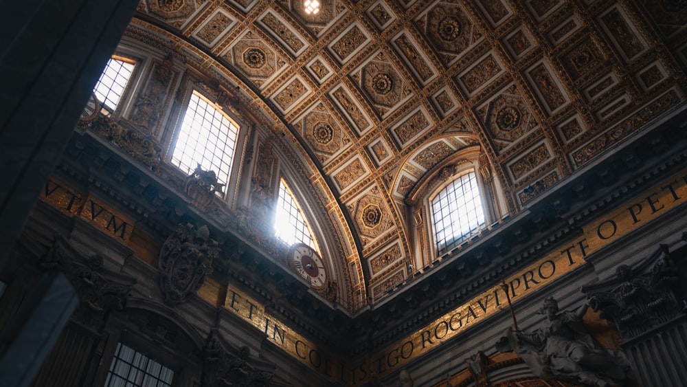 the ceiling of a large building with many windows