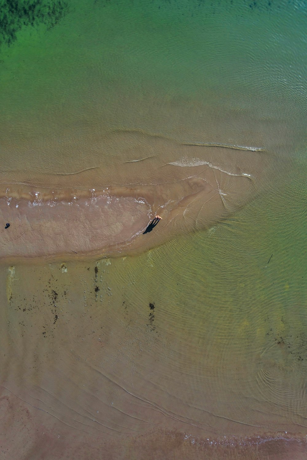 an aerial view of a boat in a body of water