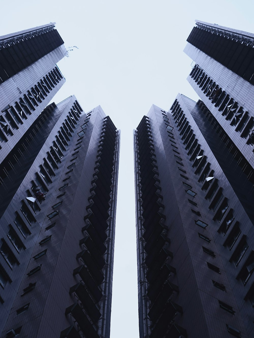 looking up at tall buildings in a city