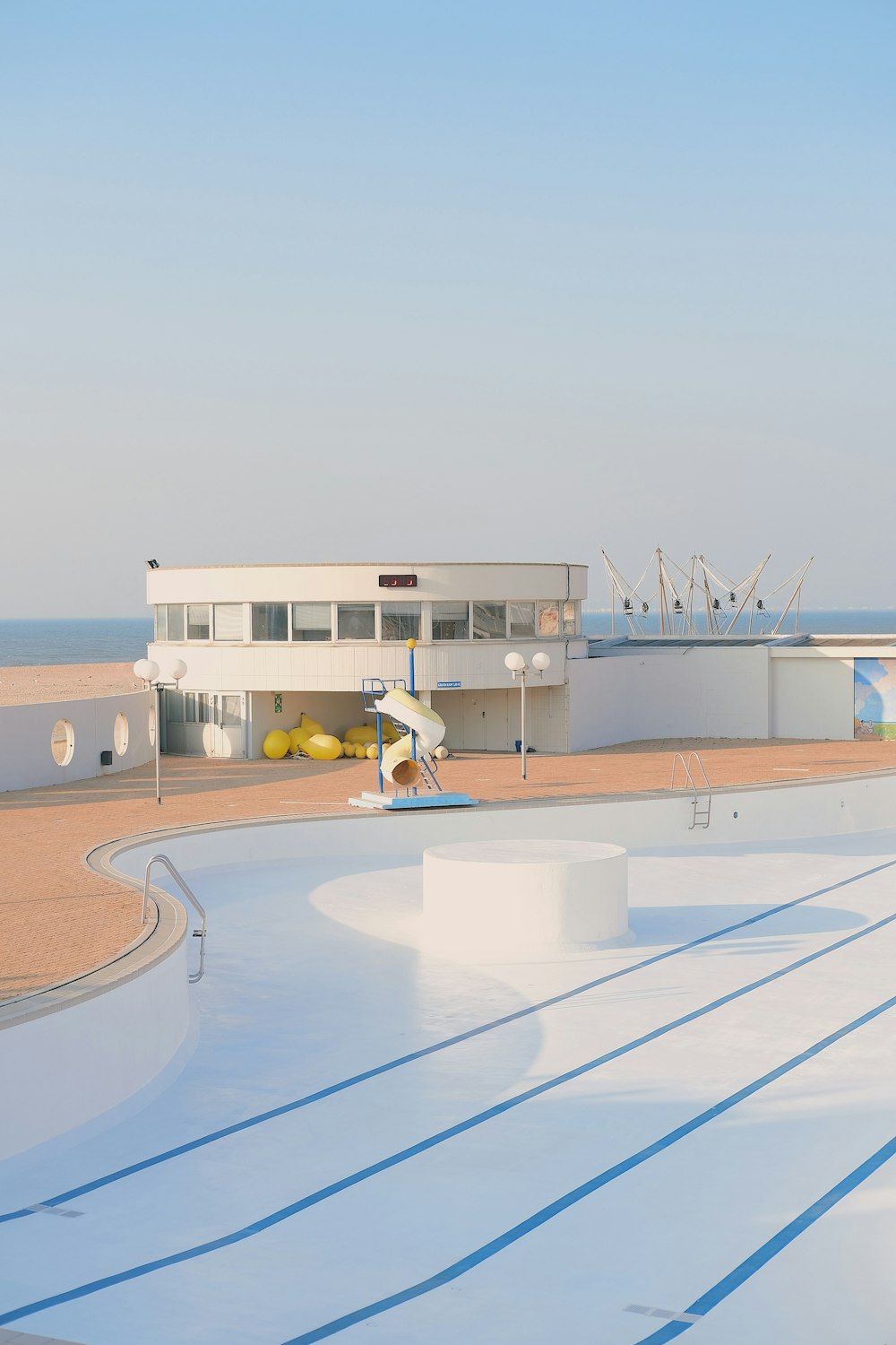 a large swimming pool with a slide in the middle of it