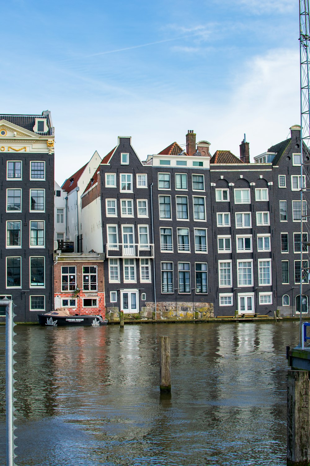 a large body of water next to a row of buildings