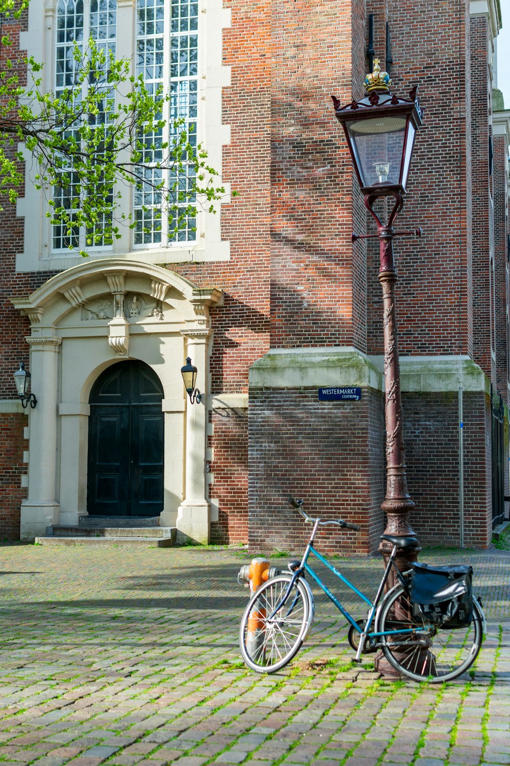 a bicycle parked next to a lamp post