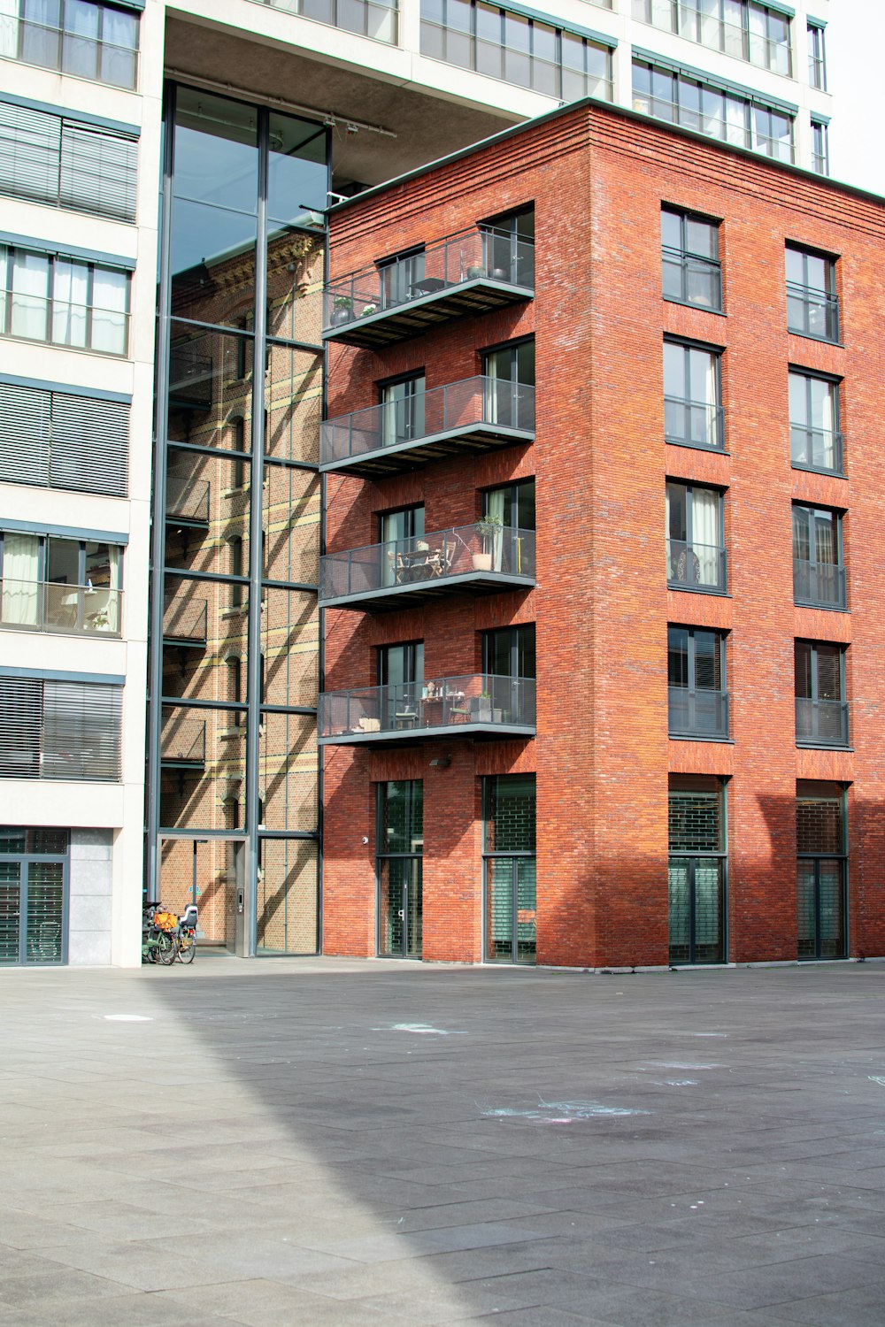 a man riding a skateboard down a street next to a tall building